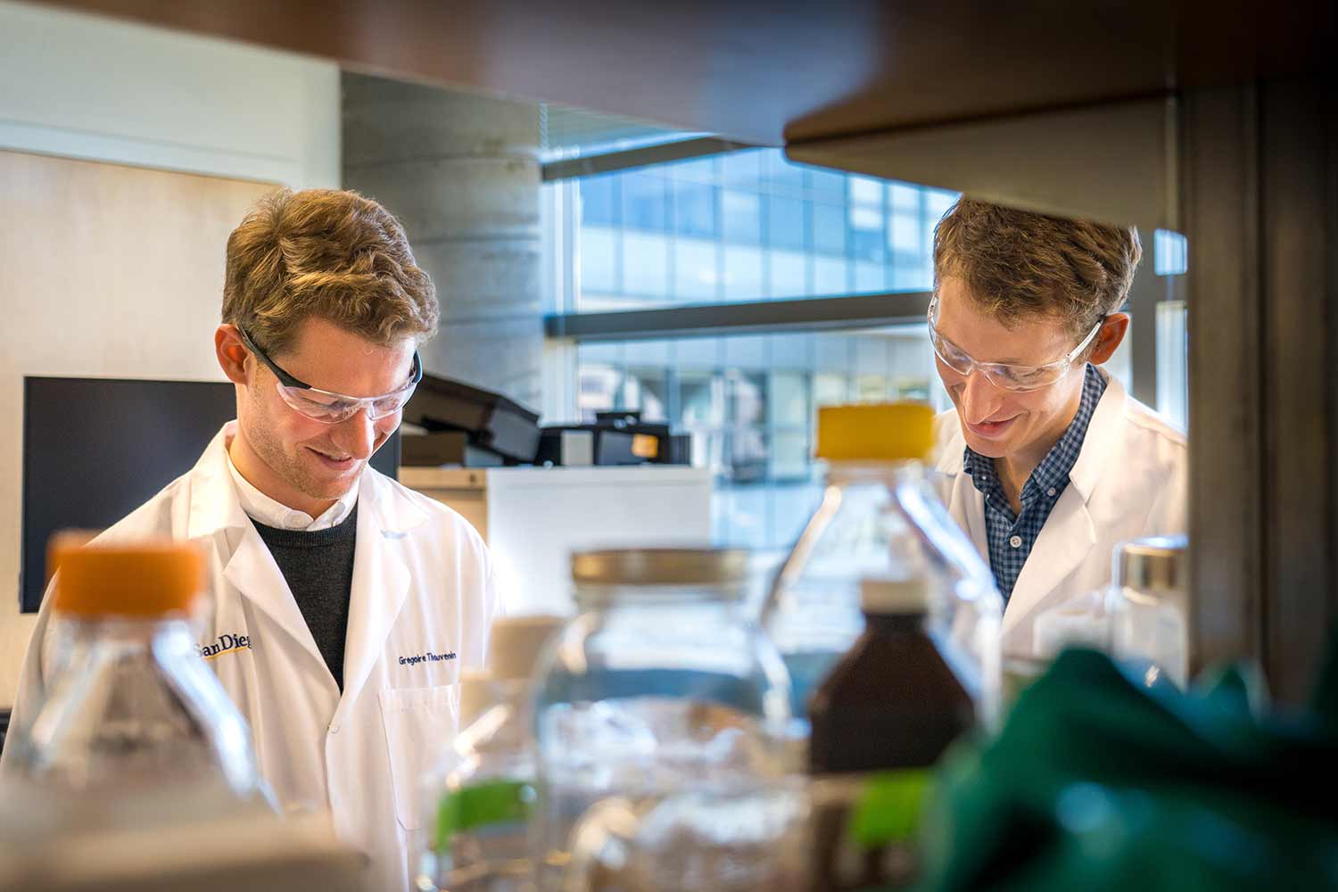 Two people in lab coats working in a laboratory