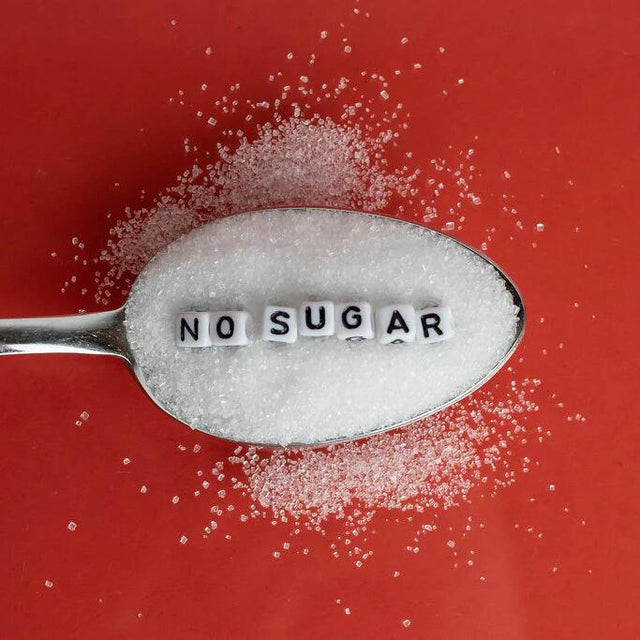 No sugar spoon on red background