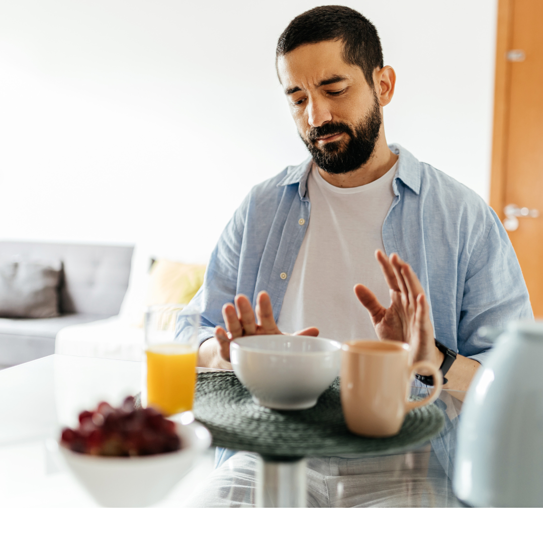 Person sitting at breakfast with little appetite