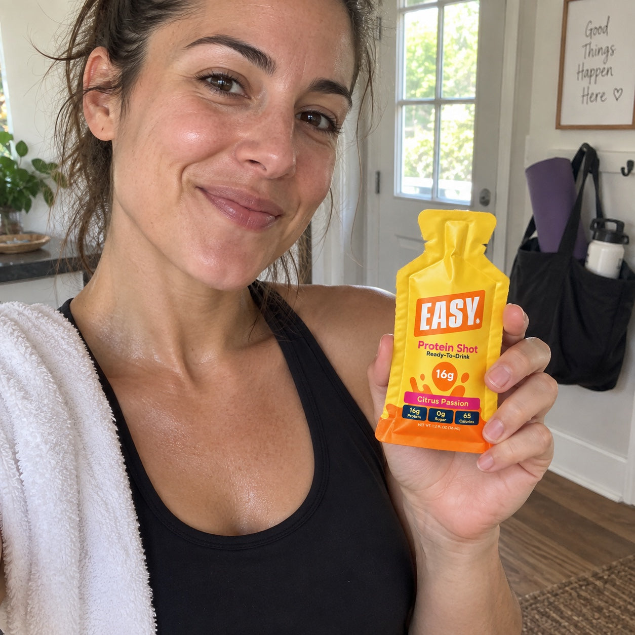 Brand-created candid scene of a customer holding an Easy Protein® Citrus Passion pouch after a workout